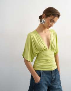 Model wearing V-neck tie detail top in lime