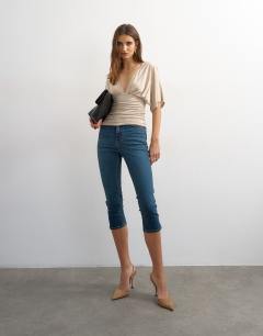 Model wearing V-neck tie detail top in oat