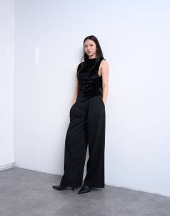 Model wearing Velvet drop armhole ruched side top in black