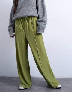 Model wearing Velvet mid rise tie waist wide leg jogger in bright green