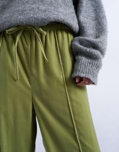 Model wearing Velvet mid rise tie waist wide leg jogger in bright green