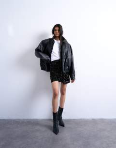 Model wearing Velvet sequin drape mini skirt in black