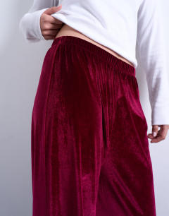 Model wearing Velvet wide leg pull on trouser in burgundy