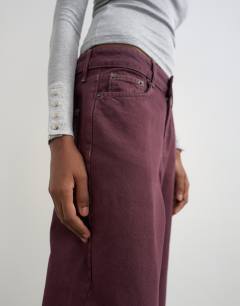 Model wearing Vintage straight mid rise jean in aubergine