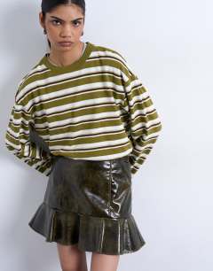 Model wearing Vinyl peplum hem mini skirt in green