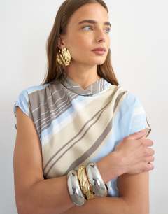 Model wearing Viscose grown on sleeve dress in blue and grey stripe