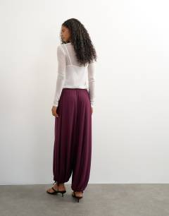 Model wearing Viscose jersey balloon trouser in plum