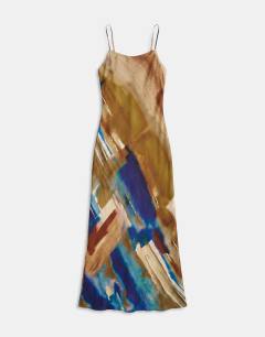 Model wearing Viscose satin low scoop flood length maxi slip dress in abstract ochre print