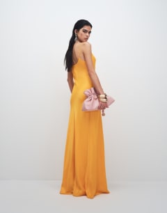 Model wearing Viscose satin low scoop flood length maxi slip dress in orange