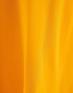 Model wearing Viscose satin low scoop flood length maxi slip dress in orange