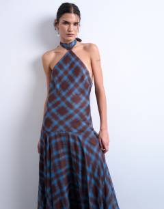 Model wearing Volume hem dropped waist maxi dress in blue check chiffon