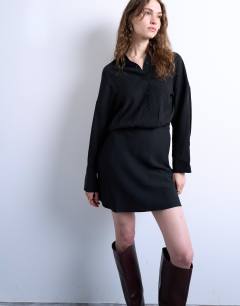 Model wearing Waisted micro mini shirt dress in black cupro