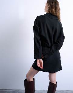 Model wearing Waisted micro mini shirt dress in black cupro