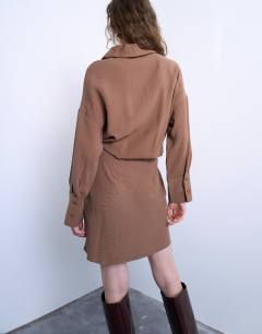 Model wearing Waisted micro mini shirt dress in brown cupro