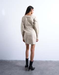 Model wearing Waisted ovoid sleeve slash neck mini dress in taupe