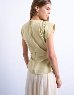 Model wearing Waisted structured shoulder top in buttermilk