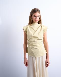 Model wearing Waisted structured shoulder top in buttermilk
