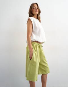 Model wearing Washed long line tie detail shorts in washed lime