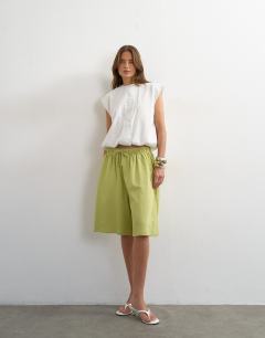 Model wearing Washed long line tie detail shorts in washed lime