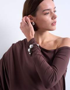 Model wearing Waterfall cape one shoulder long sleeve top in chocolate
