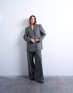 Model wearing Wide pleat trousers in grey