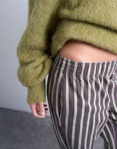 Model wearing Wide stripe pull on straight leg trouser in green and brown