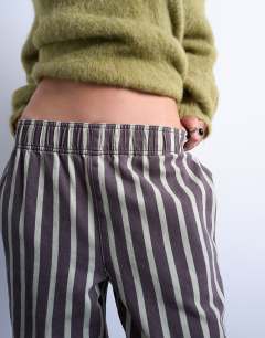 Model wearing Wide stripe pull on straight leg trouser in green and brown