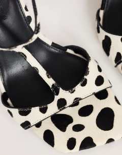 Model wearing Willow T bar banana heel sandal in dalmatian hair on real leather