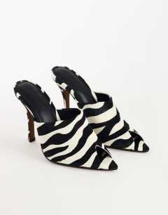 Model wearing Winona high vamp peep toe heeled sandal in zebra hair on real leather