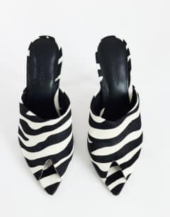 Model wearing Winona high vamp peep toe heeled sandal in zebra hair on real leather