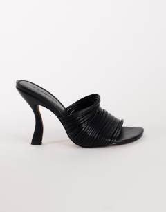 Model wearing Wisteria strappy heeled mule in black
