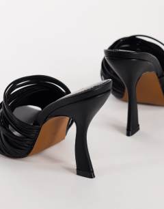 Model wearing Wisteria strappy heeled mule in black