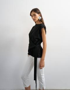Model wearing Wrap detail cap sleeve top in black