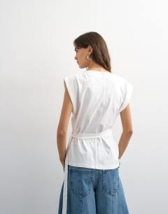 Model wearing Wrap detail cap sleeve top in ecru