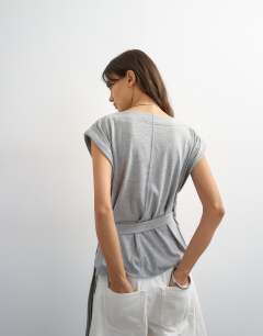 Model wearing Wrap detail cap sleeve top in grey marl