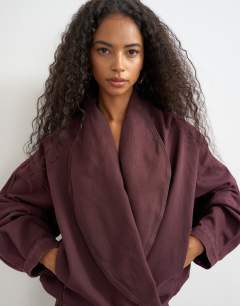 Model wearing Wrap drape neckline bomber jacket in aubergine