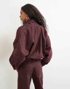 Model wearing Wrap drape neckline bomber jacket in aubergine