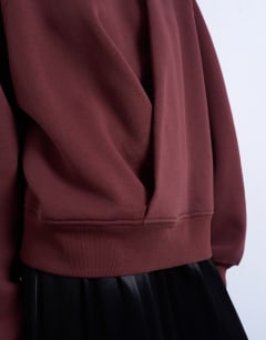 Model wearing Wrap front detail sweatshirt in chocolate