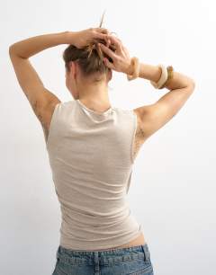 Model wearing Wrap front drape detail tank in oat
