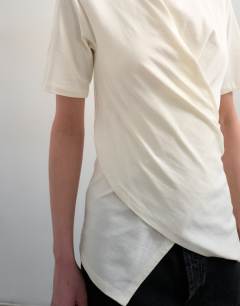 Model wearing Wrap front half sleeve top in ecru