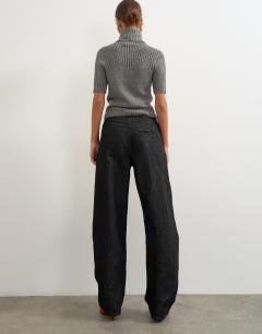 Model wearing Wrap Front jean washed black
