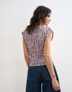 Model wearing Wrap front short sleeve top in multi