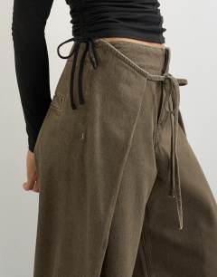 Model wearing Wrap front tie tailored jean in olive