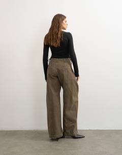 Model wearing Wrap front tie tailored jean in olive