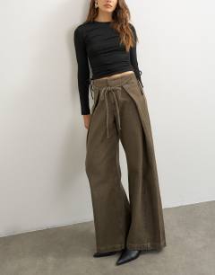 Model wearing Wrap front tie tailored jean in olive