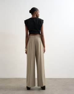 Model wearing Wrap over tailored trouser in stone