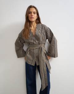 Model wearing Wrap tie detail top in check print