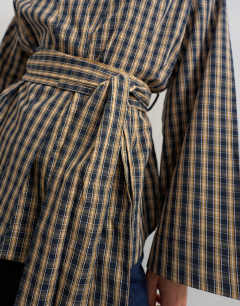 Model wearing Wrap tie detail top in check print