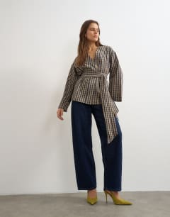 Model wearing Wrap tie detail top in check print