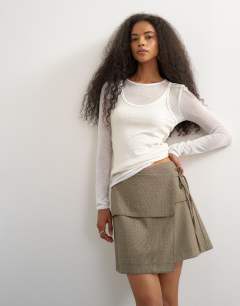 Model wearing Wrap tie mini skirt in taupe